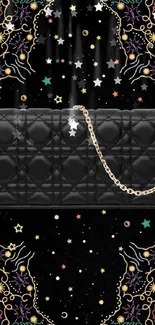 Chic black purse with gold chain on vibrant decorative background.