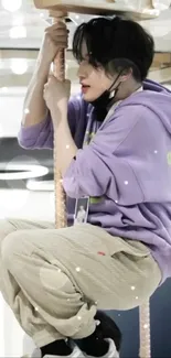 Person in a purple hoodie enjoying a carousel ride.