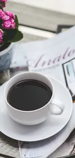 Mobile wallpaper with coffee cup, magazine, and pink flowers.