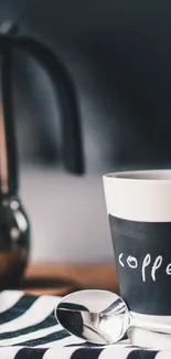 Coffee mug on striped mat with dark background.