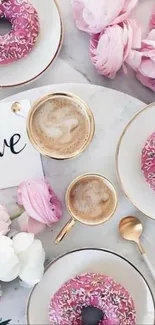 Pink donuts with coffee and flowers in a chic setup.