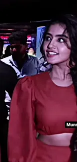 Chic woman in a vibrant red outfit at an evening event.