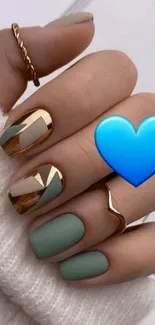 Chic gold and mint geometric nails with blue heart accent.