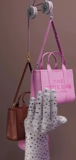 Stylish pink tote bags hanging as chic mobile wallpaper.