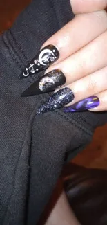 Cosmic nail art design with dark aesthetic.