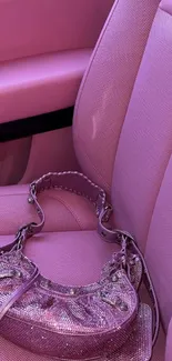 Chic pink car seat with a sparkling handbag on it.