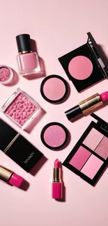 Pink makeup products arranged artistically on a light pink background.