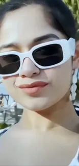 Stylish woman in sunglasses at the beach.