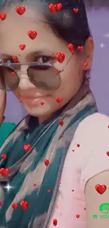 Woman wearing sunglasses with heart decorations on phone wallpaper.