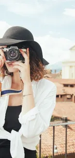 Stylish woman photographing an urban cityscape.