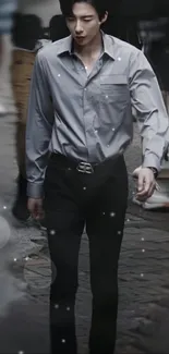 Man in a stylish gray outfit walking on an urban street.