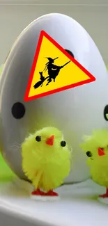 Yellow chicks and decorative egg with witch sign.