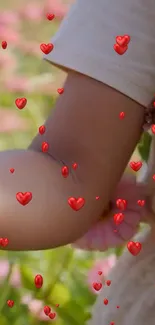 Child's arm with floating red hearts, nature background.