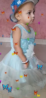 Child in blue dress with butterflies on wallpaper.