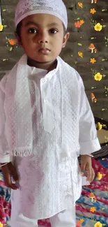 Child in traditional white attire with floral background.