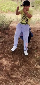 Child swinging outdoors with nature background.