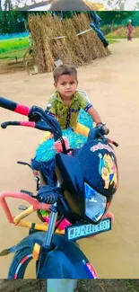 Young child on a colorful bike in a rural setting