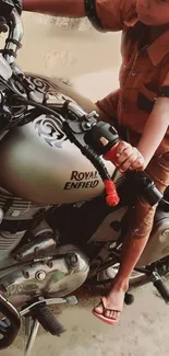 Child sitting on a Royal Enfield motorcycle.