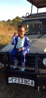 Young child on jeep safari with scenic background.