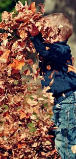 Child gleefully playing in a pile of autumn leaves outdoors.