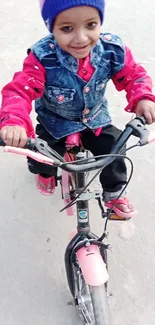 Smiling child joyfully riding a bicycle.