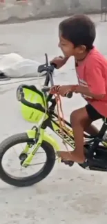 Joyful child cycling outdoors on a lime green bike.