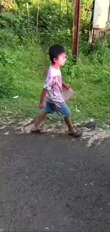 Child walking on road with green nature background.