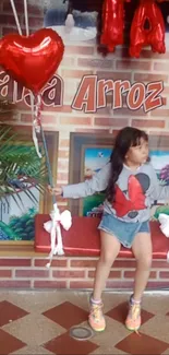 Young girl on swing with red heart balloons.