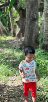 Child walking along a forest path surrounded by trees.