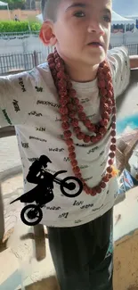 Child wearing necklaces with motorbike silhouette design in urban background.