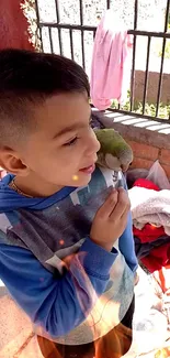 Young boy with a parrot on shoulder, outdoors, colorful scene.