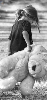 Black and white image of a girl with a stuffed animal.