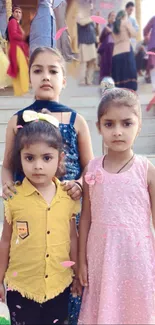 Three children in festive attire during a celebratory event.