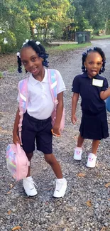 Two happy children with backpacks on a gravel path under trees, heading to school.