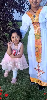 Children in colorful traditional dress with smiling faces and vibrant background.