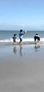 Children playing at the beach with ocean waves in the background.