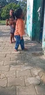 Kids playing outside near a green gate.