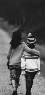 Two children walking down a rural path in black and white setting.