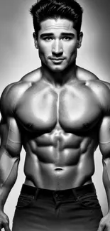 Black and white portrait of a muscular male model showcasing chiseled body aesthetics.