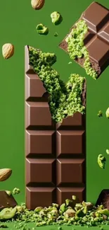Chocolate bar with matcha and almonds on green background.