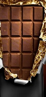 Close-up of a chocolate bar with gold foil wrap.