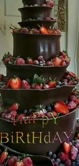 Chocolate birthday cake with berries and decorations.