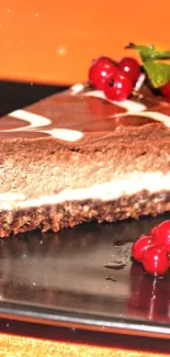 Chocolate cheesecake on black plate with berries.