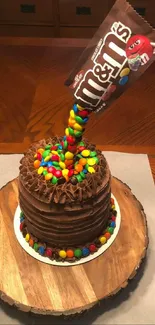 Chocolate cake with an M&M's anti-gravity effect on a wooden platter.