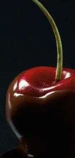 Mobile wallpaper featuring a chocolate-dripped red cherry on a dark background.