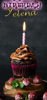 Chocolate cupcake with candle on dark background.