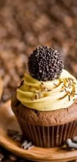 Chocolate cupcake with creamy frosting on a wooden plate.