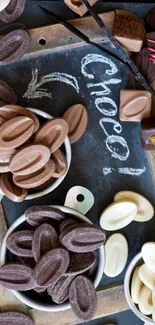 Assorted chocolates on a vintage blackboard background for phones.