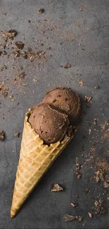 Chocolate ice cream in waffle cone on dark background.