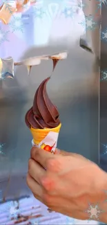Hand holding chocolate ice cream cone with snowflake border.